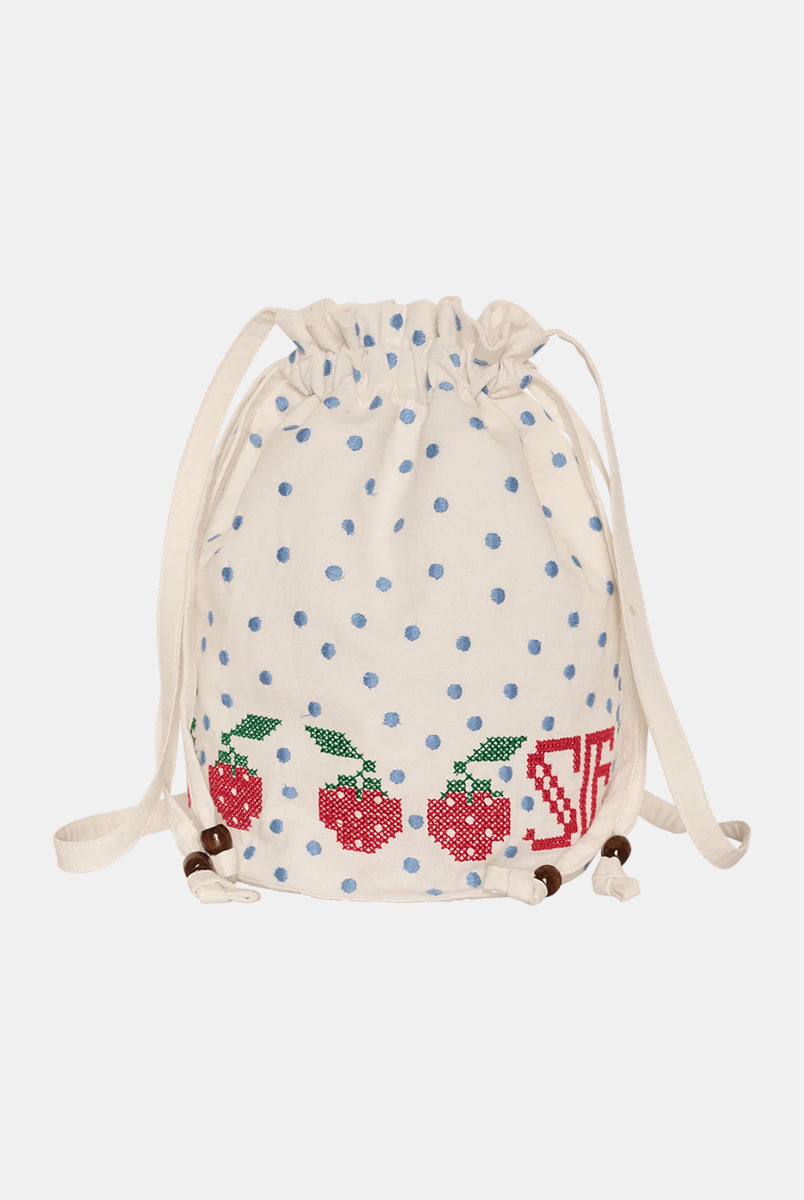 Torebka na ramię Babba Drawstring Off White marki SISSEL EDELBO z bawełny organicznej. Zmieścisz w niej niezbędne rzeczy na co dzień. Ma okrągłe dno i można ją zamknąć za pomocą sznurków. Ozdobiona jest uroczymi, niebieskimi kropkami i haftem krzyżykowym wzdłuż dolnej krawędzi, a także małym, haftowanym napisem SE.