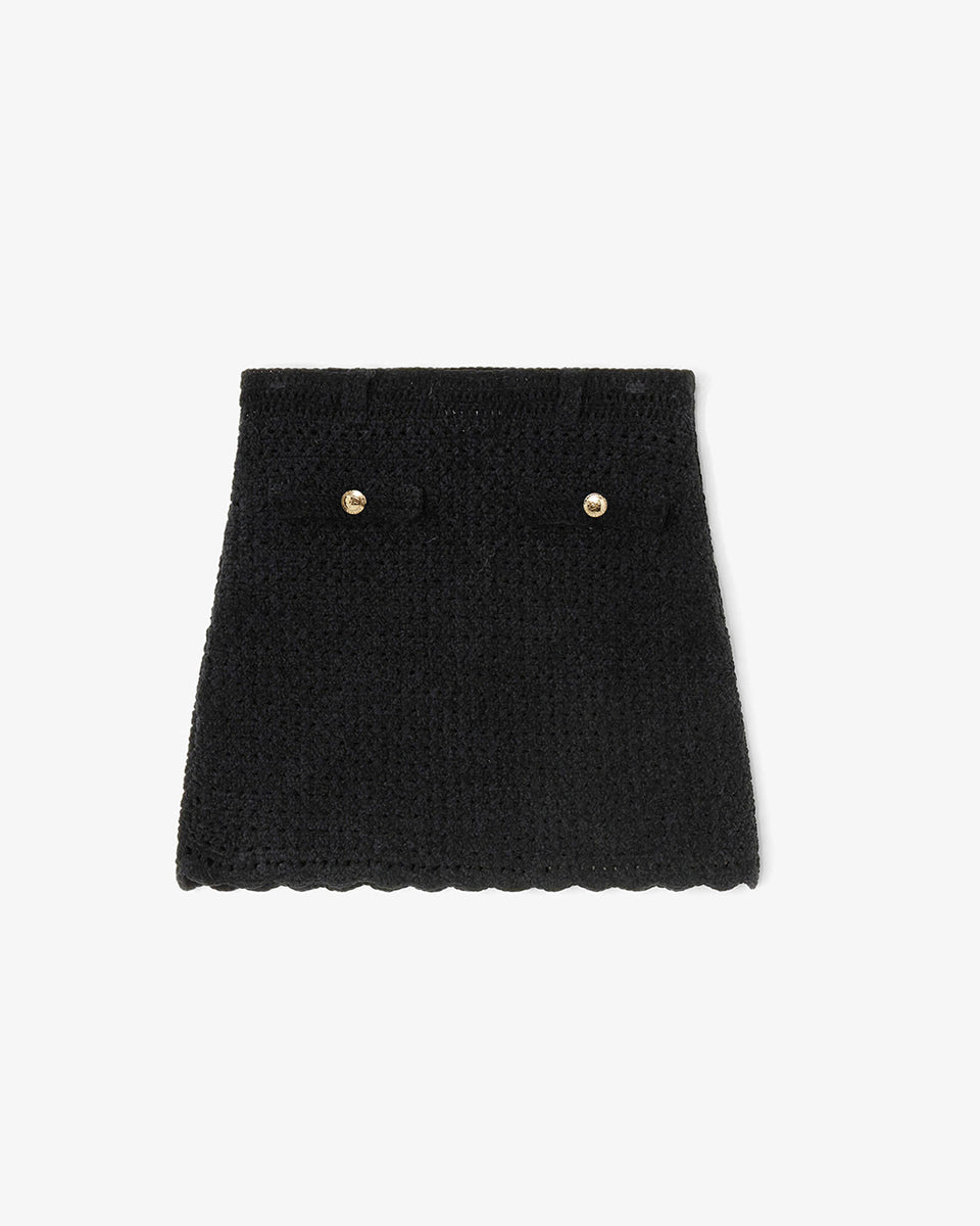 Lekko trapezowa, mini spódnica Chenille Crochet Black marki GANNI z dzianiny z bawełny organicznej o szydełkowym splocie. Zapinana na zamek błyskawiczny. Posiada dwie naszywane kieszenie z patkami, ozdobione złotymi guzikami. U dołu wykończona delikatną falbanką.
-Trapezowy krój
-Ozdobne guziki
-Szydełkowy splot
-Zamów spódnicę w rozmiarze, który nosisz zazwyczaj