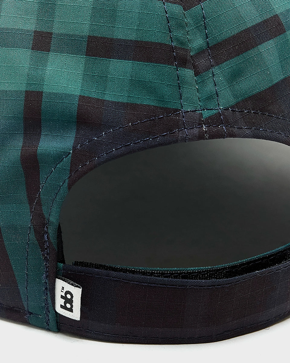 Klasyczna czapka bejsbolówka Delcro Plaid marki BELLEROSE w czarno-granatowo-zieloną kratę, z haftowanym logo marki i regulowanym paskiem na rzep. 