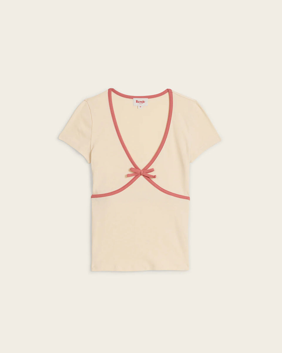Dopasowany, uroczy t-shirt Karene Ecru z krótkim rękawem i dekoltem w serek z kontrastową lamówką wykończoną kokardką. Wykonana z bawełny organicznej. Idealny do spodni z wysokim stanem.
-Przylegający fason
-Bawełna organiczna
-Zamów bluzkę w swoim normalnym rozmiarze. Jeśli wypadasz między rozmiarami - zamów większy