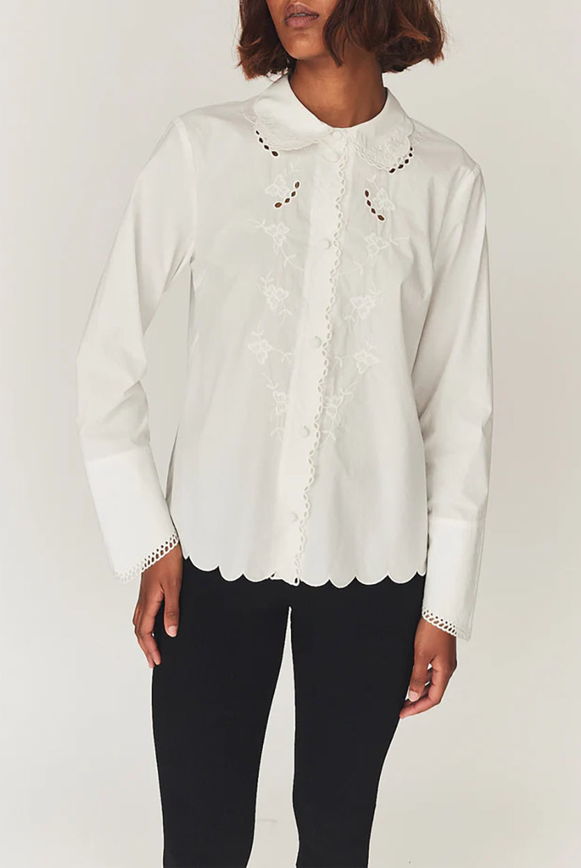 Romantyczna, klasyczna koszula Kirsten Collar White marki The Garment z zaokrąglonym kołnierzykiem z haftem angielskim i ażurowymi wycięciami. Posiada bardzo wysokie, eleganckie mankiety. Na piersiach i wzdłuż linii guzików znajdują się delikatne, kwiatowe hafty. Zapinana na drobne guziki. Brzeg koszuli oraz listwa guzikowa wykończone są falistym brzegiem. Wykonana z bawełny organicznej.
-Ozdobiona haftem angielskim
-Faliste brzegi
-Zamów koszulę w swoim standardowym rozmiarze