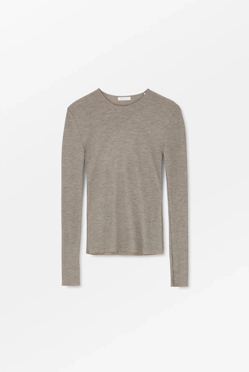 Minimalistyczny, cienki, wełniany longsleeve Amy O-neck SKALL z okrągłym dekoltem i wąskimi, długimi rękawami. Posiada przylegający do ciała fason i delikatną fakturę w prążki