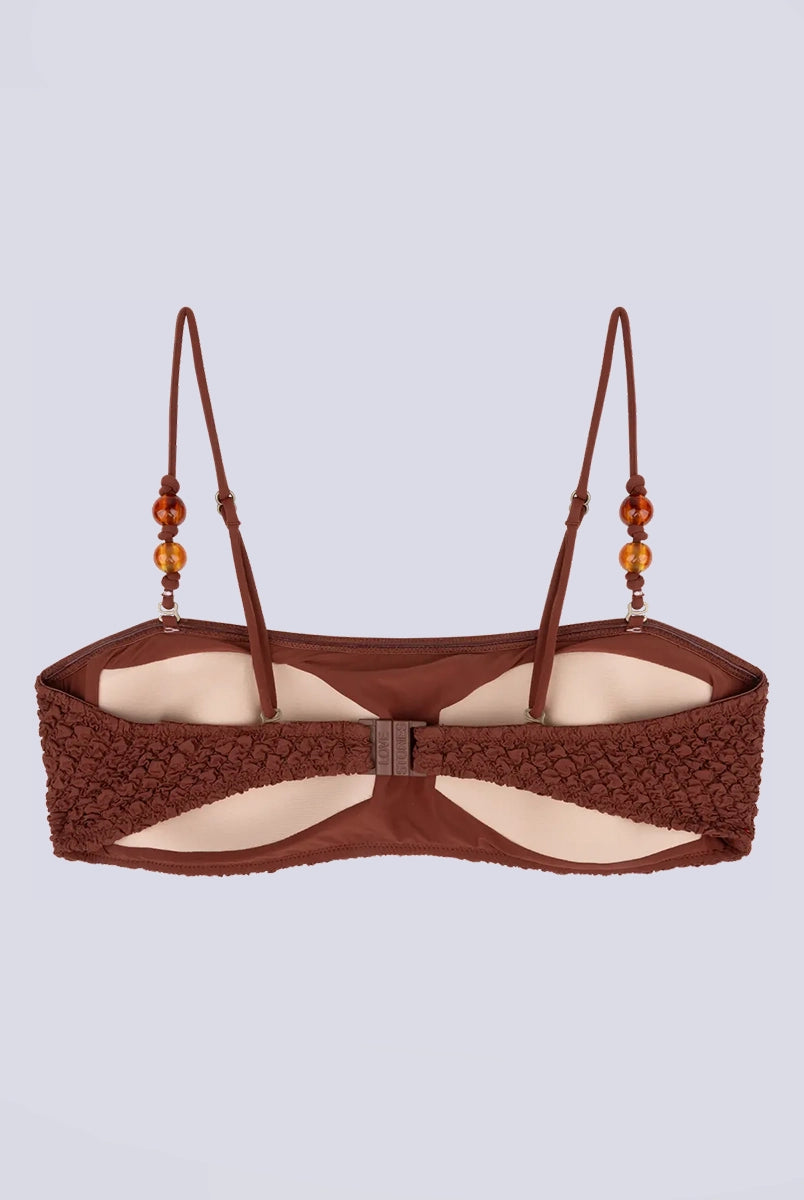 Góra od bikini w stylu bandażowym Bondi Love Stories z utwardzającymi wkładkami. Posiada cienkie, odpinane ramiączka z koralikami. Wykonana z tkaniny z fakturą.
