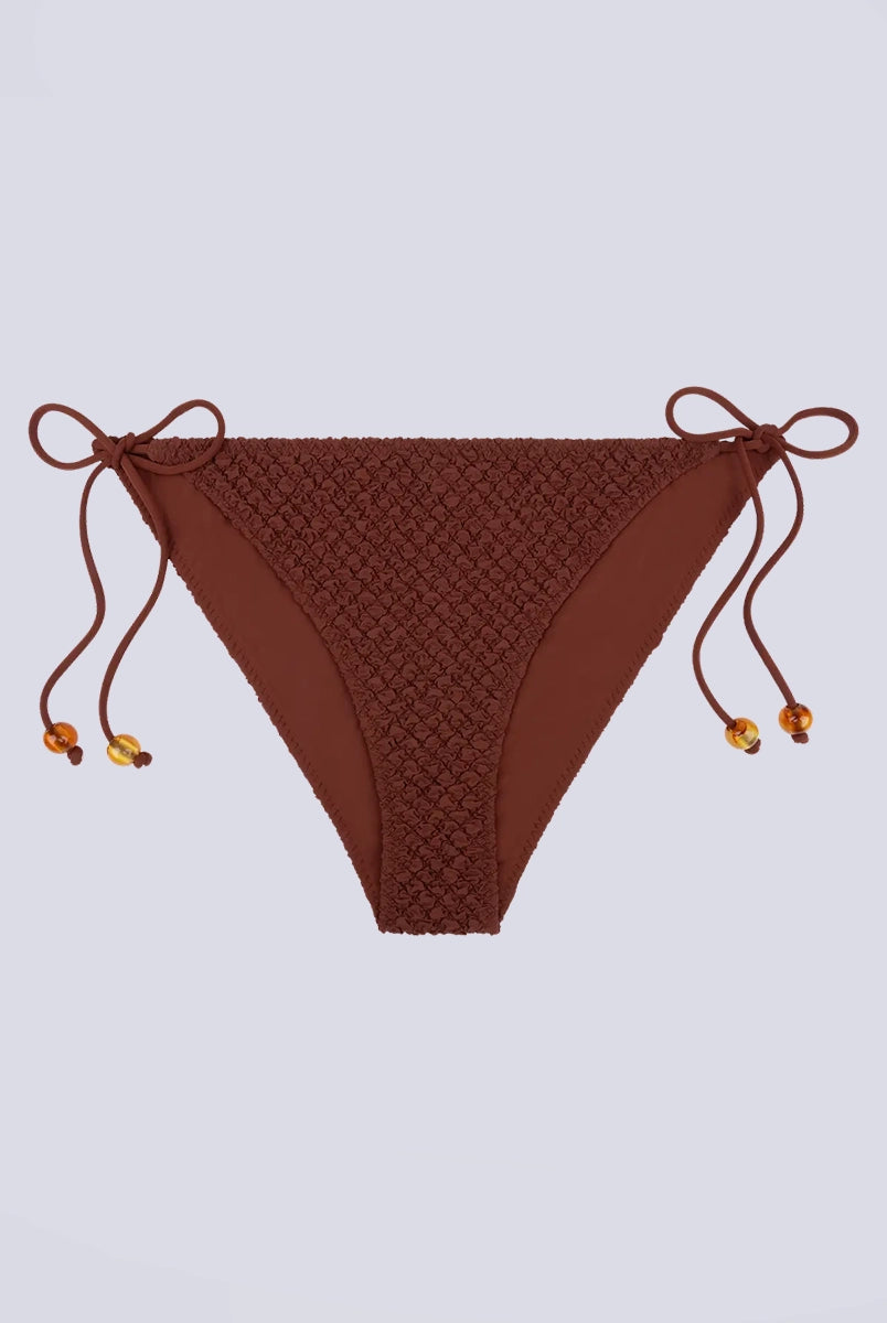 Klasyczny dół od bikini z niskim stanem Vanity Love Stories i z wiązaniem po bokach. Na sznurkach znajdują się efektowne koraliki.