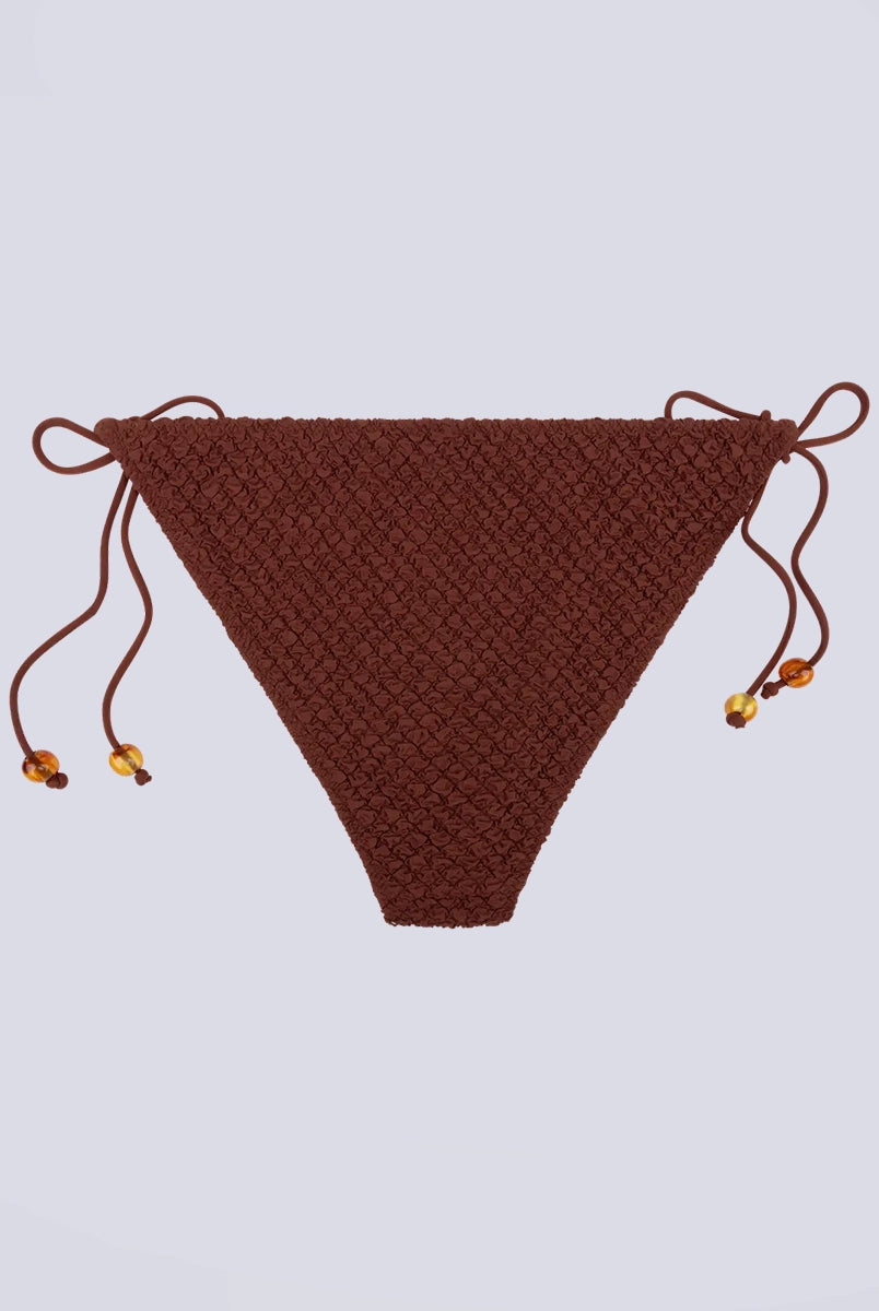 Klasyczny dół od bikini z niskim stanem Vanity Love Stories i z wiązaniem po bokach. Na sznurkach znajdują się efektowne koraliki.