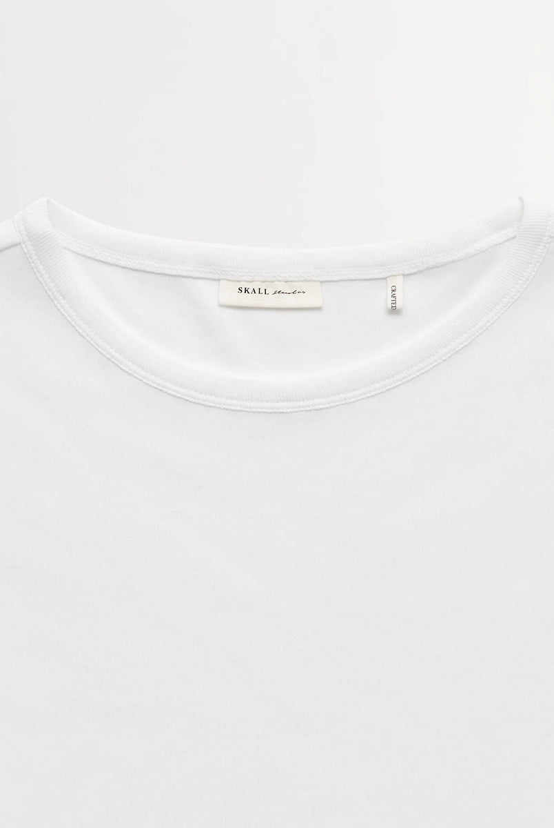 Minimalistyczny, biały, bawełniany longsleeve Seventies O-neck SKALL z okrągłym dekoltem i wąskimi, długimi rękawami. Posiada przylegający do ciała fason i delikatną, gładką fakturę. Wykonany z organicznej i bardzo przyjemnej dla skóry bawełny. To bluzka idealna do warstwowych stylizacji.
-Przylegający fason
-100% bawełna organiczna
-Zamów longsleeve w swoim normalnym rozmiarze