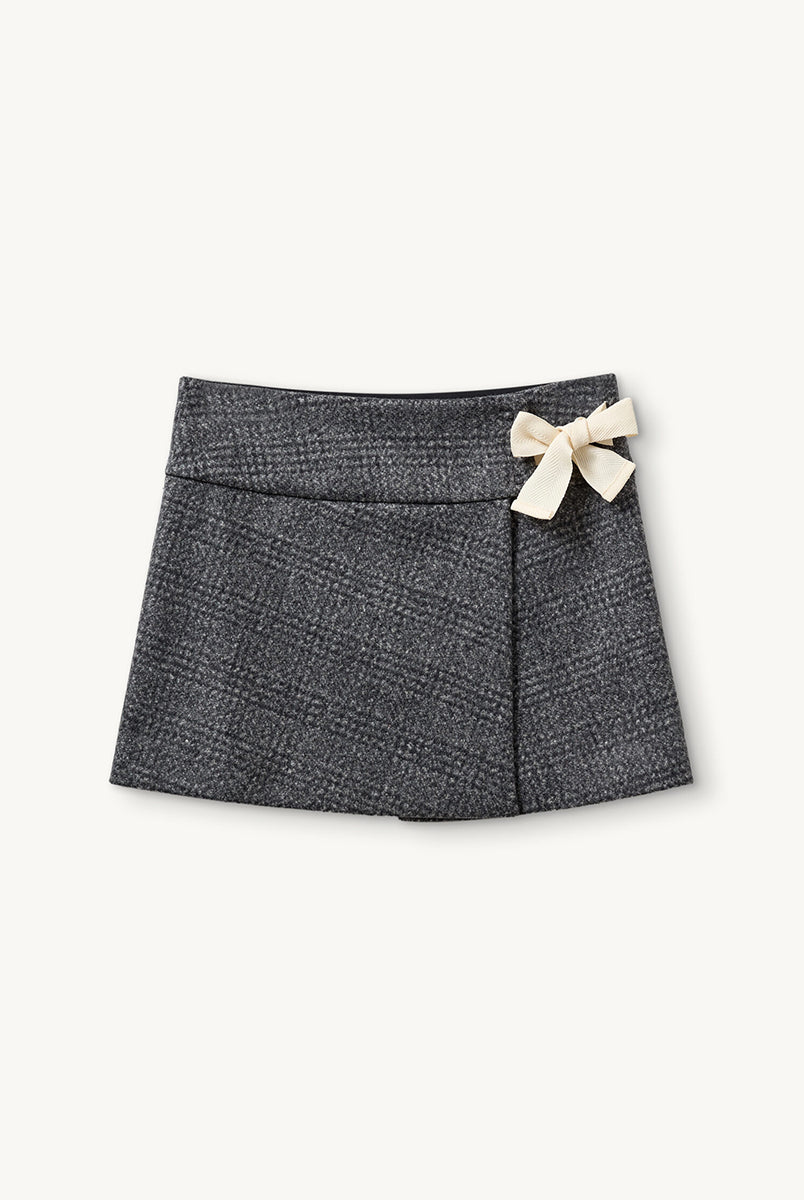 Szara, tweedowa spódnica mini z niskim stanem Brad The Garment w delikatną, czarną kratę. Z boku dekorowana uroczą, białą kokardą