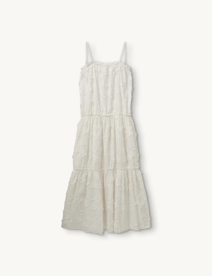 Biała, zwiewna, haftowana sukienka na cienkich ramiączkach Jewell The Garment. Posiada prosty dekolt i luźny fason. Wykonana z cienkiej bawełny organicznej.