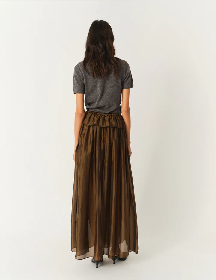 Elegancka, brązowa spódnica maxi Gilian The Garment z wysokim stanem i elastyczną talią. Na biodrach posiada falbanę. Wykonana z lekkiej, częściowo transparentnej organzy