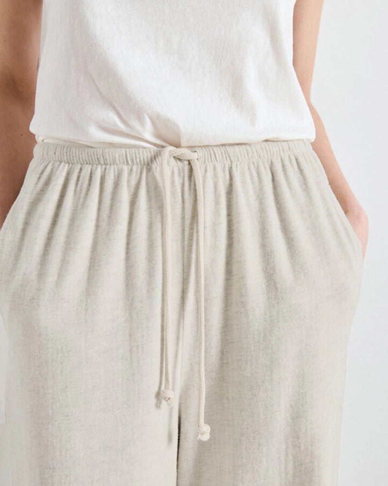 Luźne, bawełniane spodnie dresowe YPAWOOD American Vintage z wysokim stanem i szeroką, długą, prostą nogawką. Wiązane i elastyczne w talii. Wykonane z bardzo miękkiej, miłej w dotyku i komfortowej tkaniny.&nbsp;