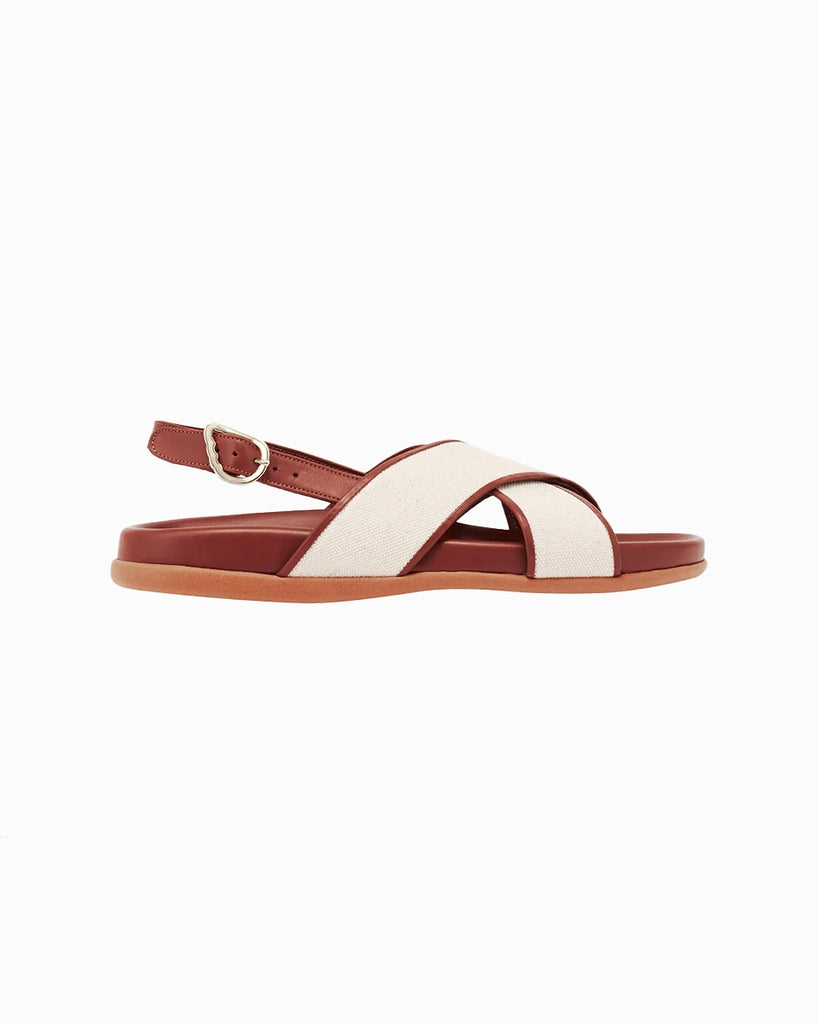 Skórzane sandały Ikesia Ancient Greek Sandals na płaskiej, profilowanej od wewnętrznej strony podeszwie z szerokimi, skrzyżowanymi paskami na górze obszytymi naturalną, płócienną tkaniną.