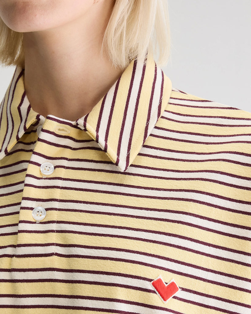 Luźna, pudełkowa koszulka polo Foolo Bellerose w paski. Posiada kołnierzyk, opadające ramiona i krótki, szeroki rękaw o długości do łokci. Pod szyją zapinana na guziki.
