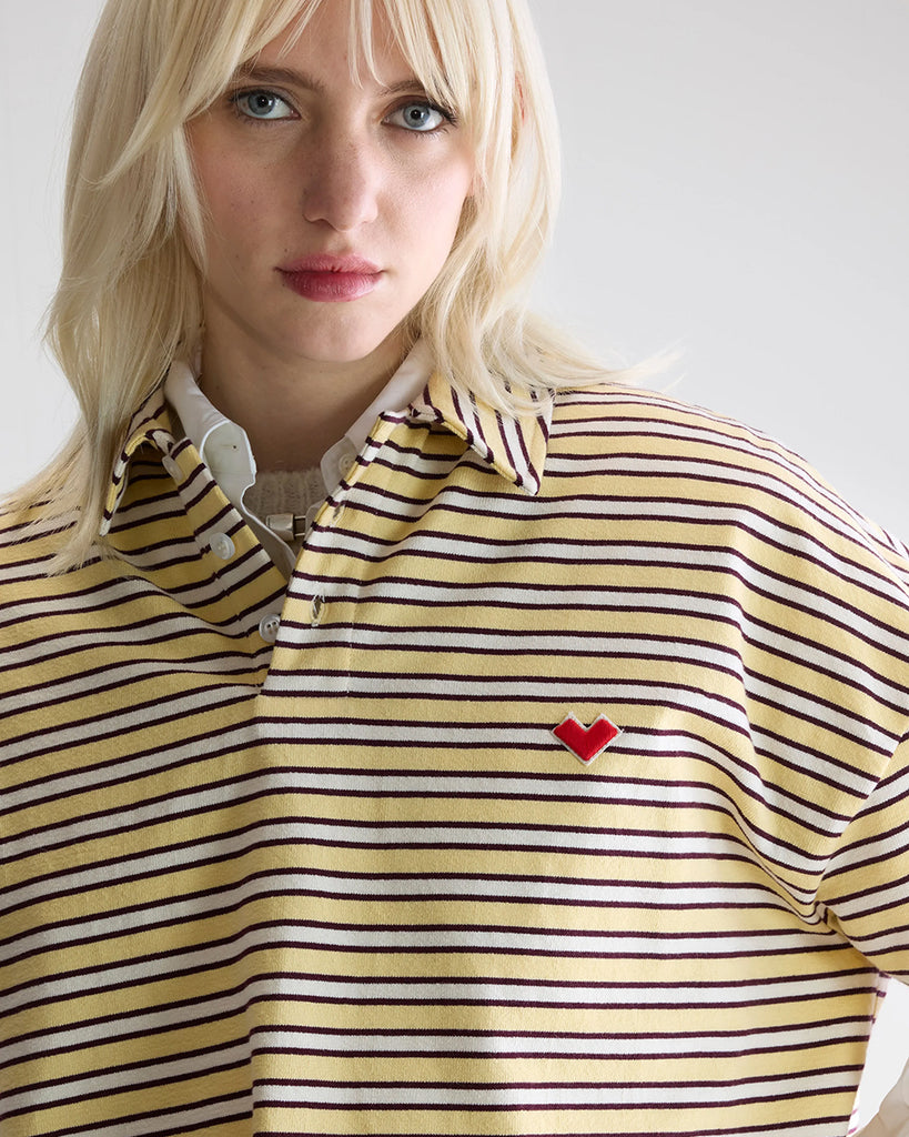 Luźna, pudełkowa koszulka polo Foolo Bellerose w paski. Posiada kołnierzyk, opadające ramiona i krótki, szeroki rękaw o długości do łokci. Pod szyją zapinana na guziki.