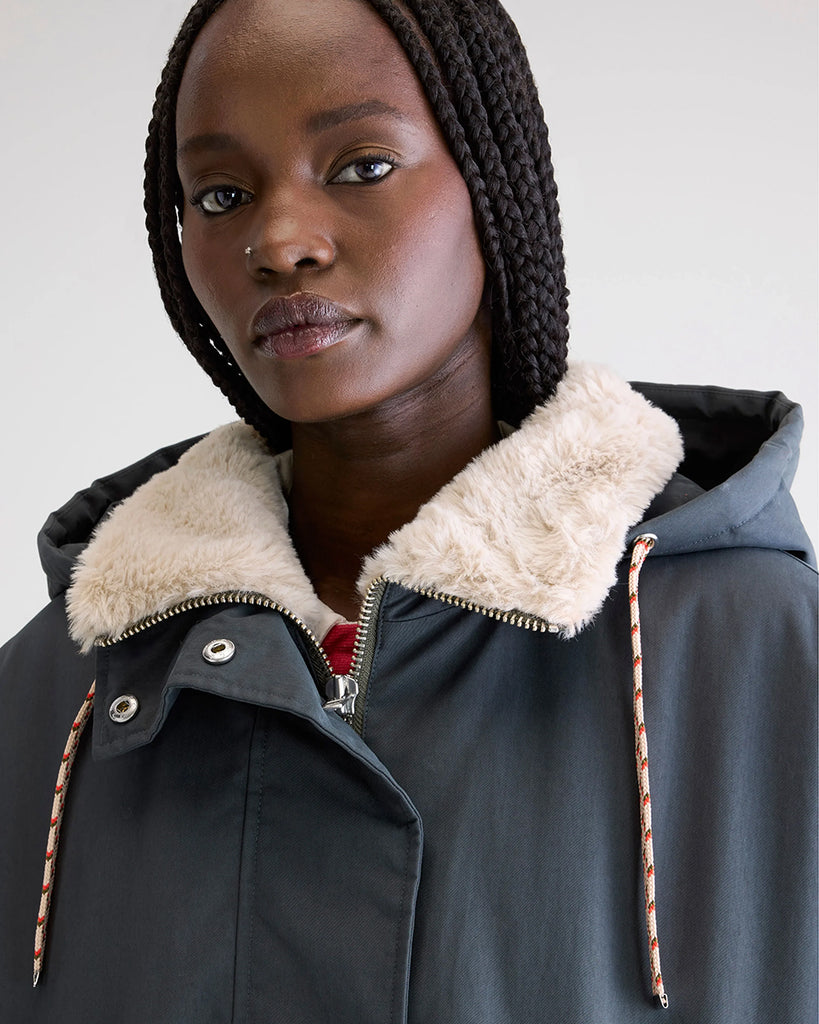 Długa, oversizowa parka Jade Bellerose z kapturem i ciepłą podpinką ze sztucznego futra w kontrastowym kolorze. Kurtka ma opadające ramiona i szerokie rękawy zakończone elastycznym ściągaczem. Posiada dwie, boczne kieszenie. 