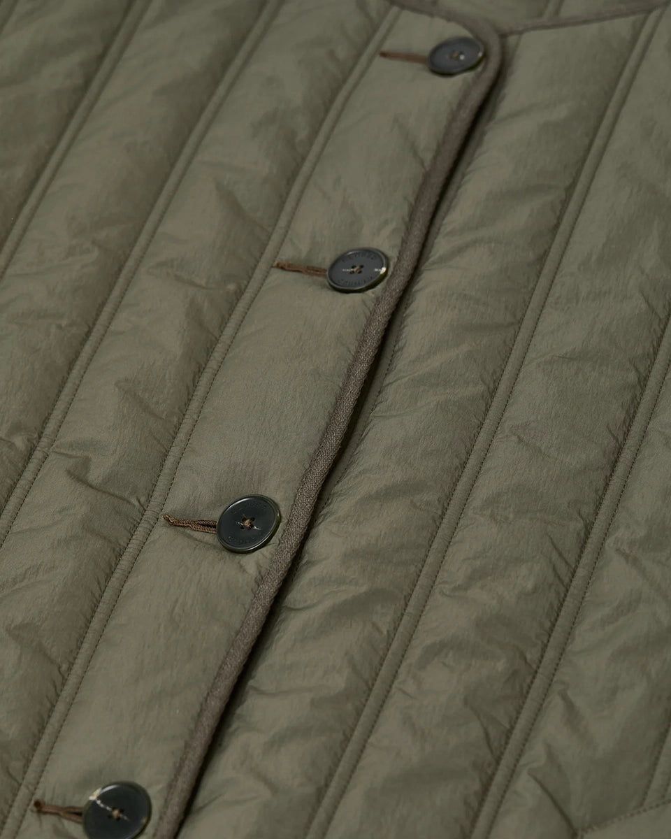 Krótka, pudełkowa, pikowana kurtka Quilted CLOSED z okrągłym dekoltem i opadającymi ramionami. Zapinana na guziki. Z boku posiada niewielkie rozcięcia oraz dwie, boczne kieszenie. Jest dłuższa z tyłu.