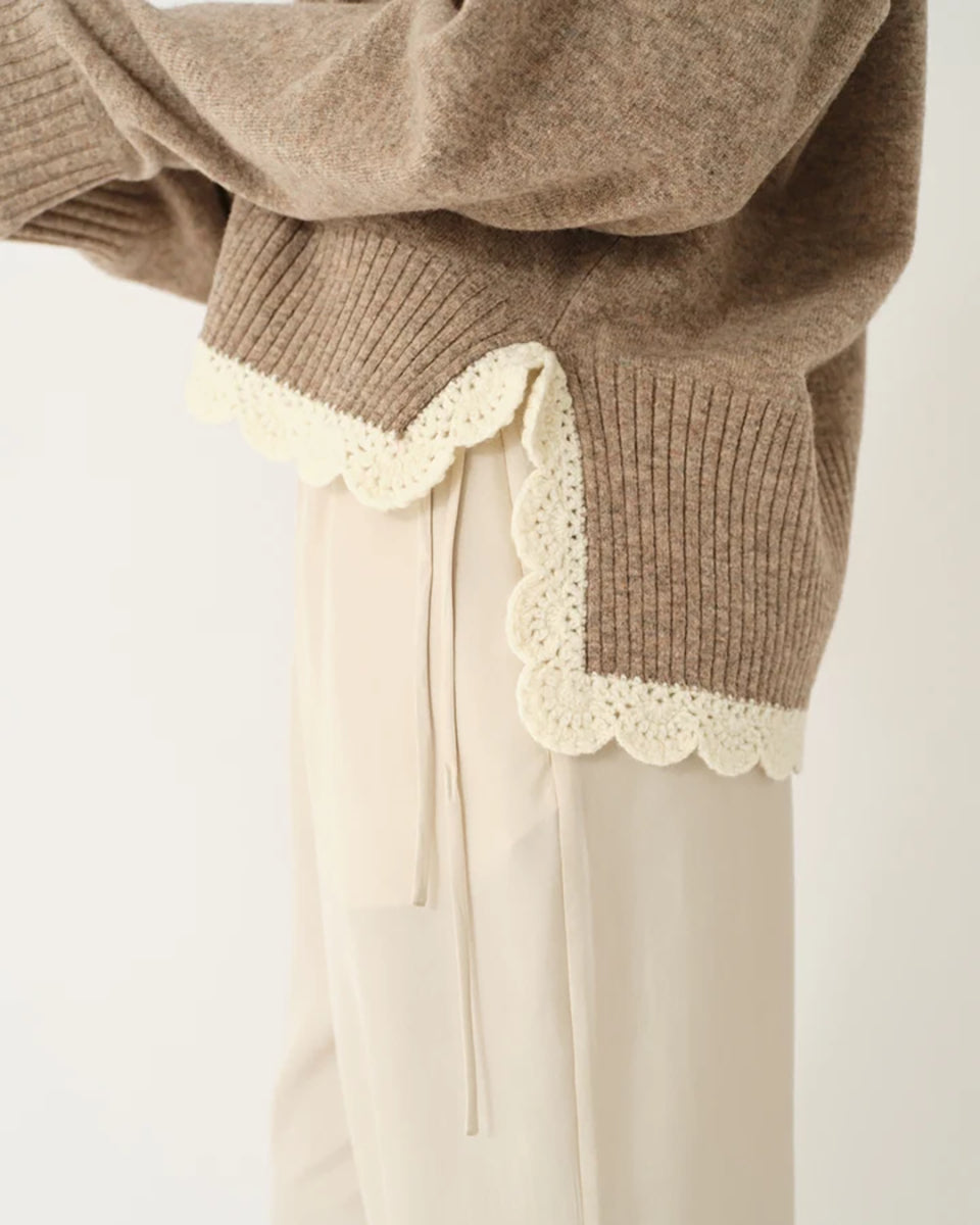 Miękki, luźny sweter Como Crochet Beige Melange z długim rękawem i dekoltem w serek. Dzięki krótszemu przodowi i dłuższemu tyłowi tworzy on korzystną dla sylwetki, swobodnie układającą się linię. U dołu wykończony jest delikatną koronką dodającą subtelnego charakteru. Wykonany z mieszanki wełny i kaszmiru.&nbsp;

-Dekolt w serek

-Wykończony pasem z koronki

-Tkanina z wełną i kaszmirem