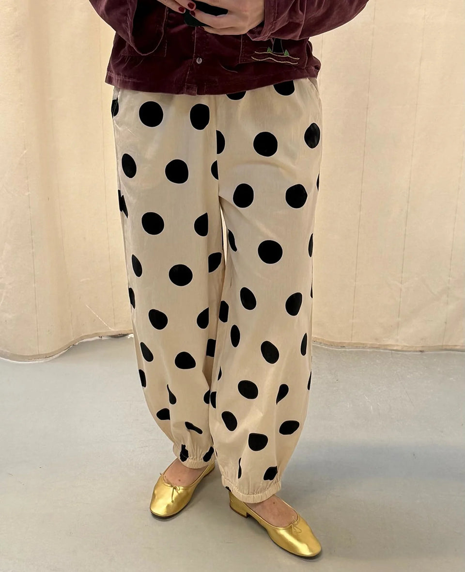 Luźne spodnie Iluna SISSEL EDELBO z żakardowej tkaniny z modnym wzorem polka dots. Posiadają szerokie, luźne nogawki zakończone wąskimi, elastycznymi ściągaczami. Spodnie mają elastyczną talię. Wykonane zostały z tkaniny pozyskanej z postprodukcji, co nadaje spodniom oryginalności i niepowtarzalności.

-Luźny fason

-Lekka tkanina w czarne grochy

-Ręcznie wykonane hafty&nbsp;

-Zamów spodnie w swoim normalnym rozmiarze