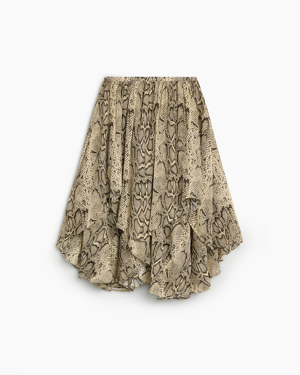 Efektowna, midi spódnica Isley TNS Snake Print wyróżnia się wężowym printem, który łączy w sobie odcienie beżu, brązu, szarości i czerni. Posiada luźny, zwiewny krój z efektownymi kaskadowymi falbanami i asymetrycznym dołem, co nadaje jej dynamicznej objętości oraz lekkości w ruchu. Model ten ma wygodny, elastyczny pas, który subtelnie marszczy materiał u góry. Dzięki warstwowej budowie spódnica pięknie faluje się i stanowi wyrazisty element każdej stylizacji.

-Długość midi

-Asymetryczny krój

-Falbany