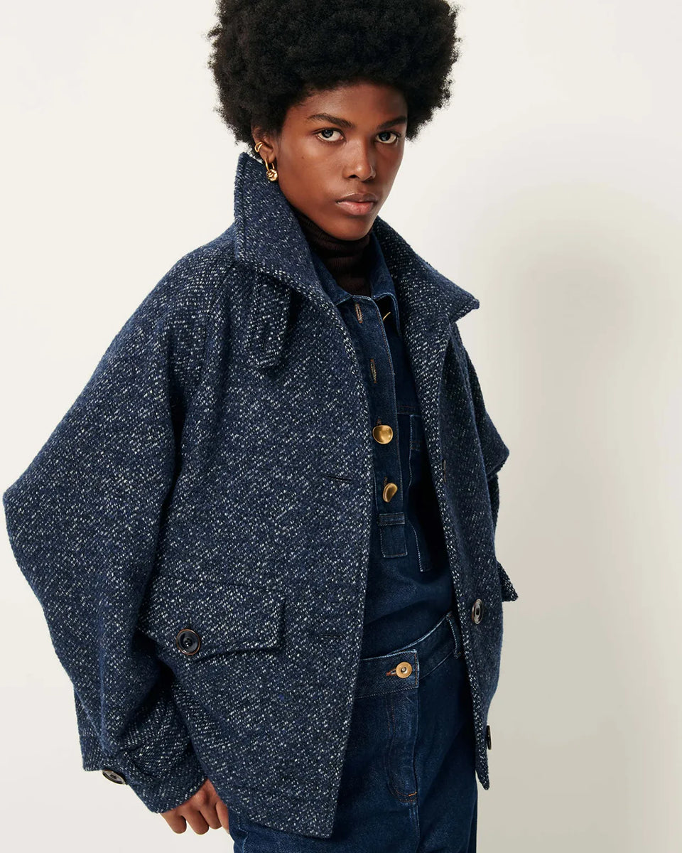 Luźny płaszcz wełniany typu bluza Lee Valley Denimwool marki Sessun wykonany z miękkiej, trójkolorowej tkaniny o splocie koszykowym, z efektem melanżowym. Posiada wysoki kołnierz, kieszenie oraz długie, raglanowe rękawy. Zapinany jest na duże guziki.