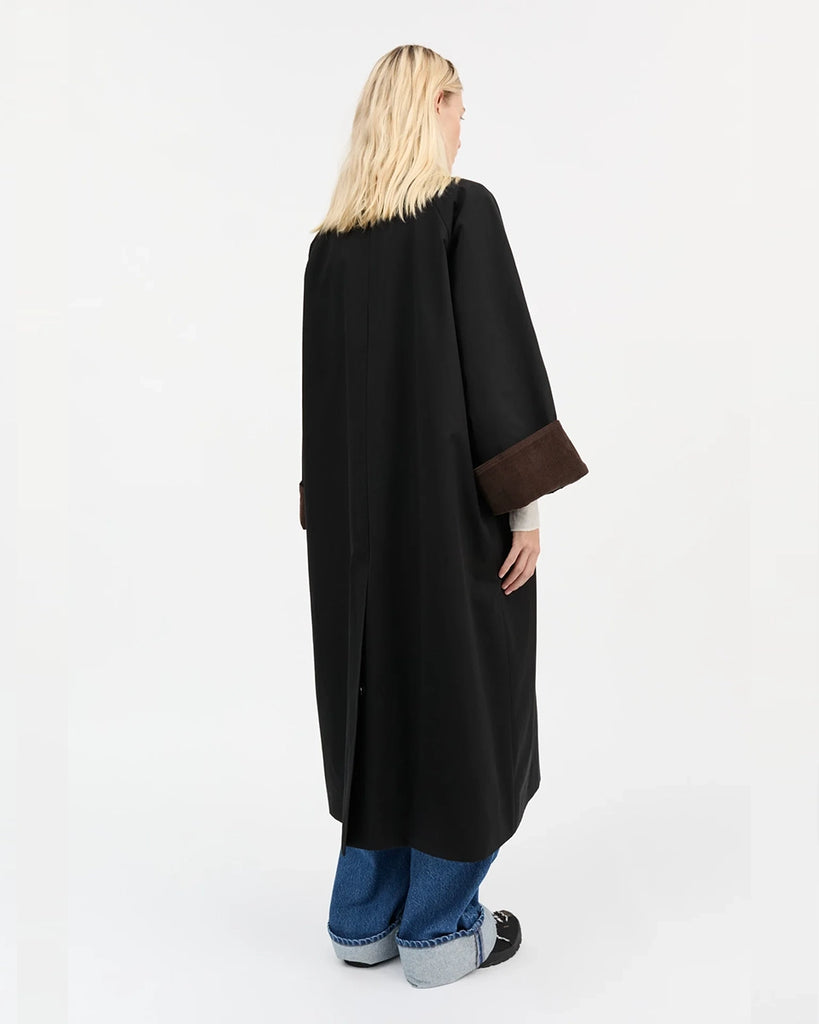 Oversizowy, przejściowy, inspirowany stylem brytyjskim płaszcz Gaby SKALL z dużym kołnierzykiem obszytym brązowym sztruksem i z szerokimi, wywijanymi rękawami ze sztruksowym obszyciem od wewnątrz mankietów. Płaszcz posiada dwie, boczne kieszenie i rozcięcie u dołu z tyłu.