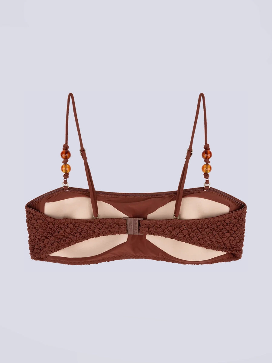 Góra od bikini w stylu bandażowym Bondi Love Stories z utwardzającymi wkładkami. Posiada cienkie, odpinane ramiączka z koralikami. Wykonana z tkaniny z fakturą.