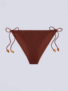Klasyczny dół od bikini z niskim stanem Vanity Love Stories i z wiązaniem po bokach. Na sznurkach znajdują się efektowne koraliki.