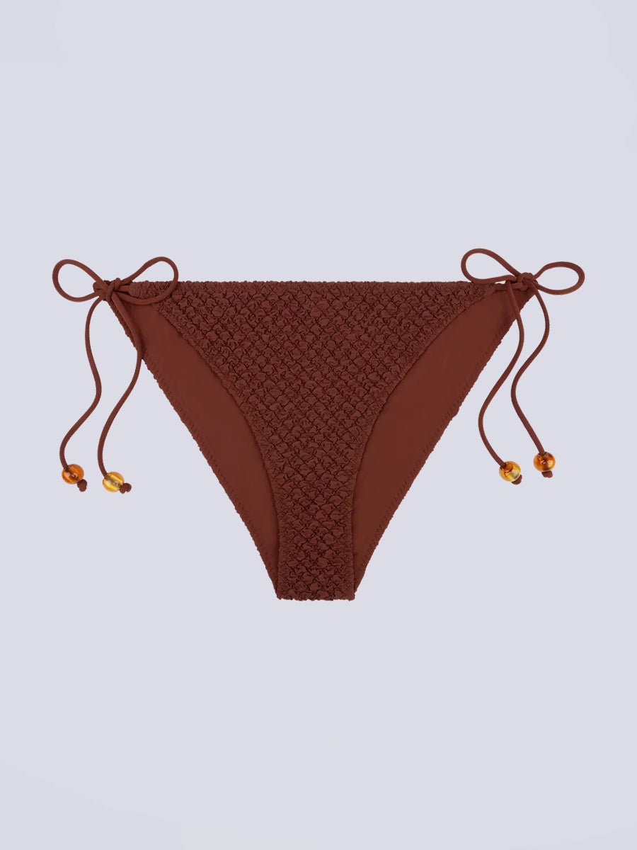 Klasyczny dół od bikini z niskim stanem Vanity Love Stories i z wiązaniem po bokach. Na sznurkach znajdują się efektowne koraliki.