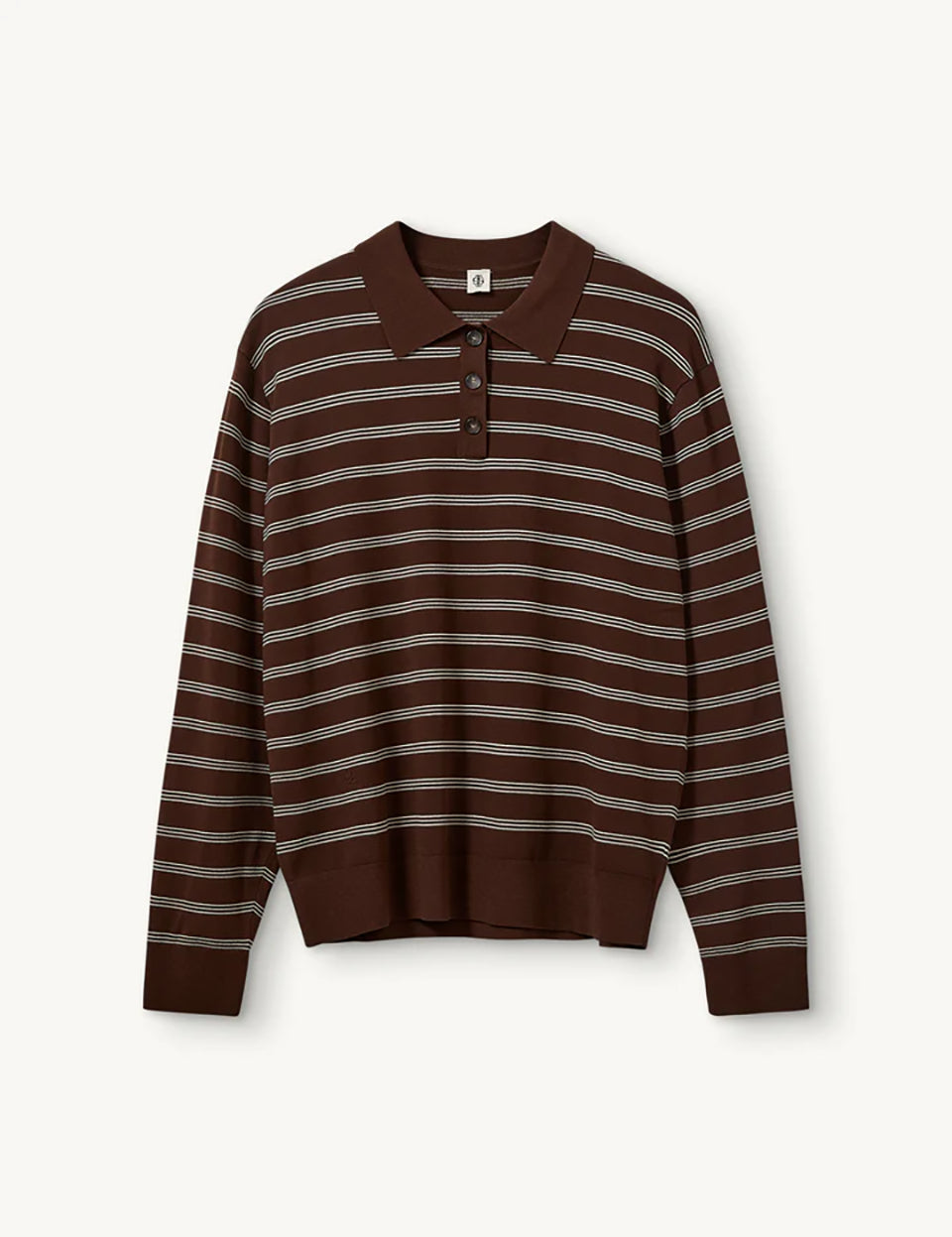 Luźny, dzianinowy longsleeve Madison Polo Espresso/Ecru w głębokim, ciepłym, brązowym odcieniu w paski, z obniżoną linią ramion i klasycznym kołnierzykiem z zapięciem na trzy guziki. Rękawy i dół zakończone są klasycznymi ściągaczami. Ma gładki, drobny splot dzianinowy. Wykonany z tkaniny z wiskozą. Zestaw go z ulubionymi jeansami, aby uzyskać klasyczną, modną stylizację.&nbsp;

-Głęboki, ciepły odcień brązu, paski

-Kołnierzyk z guziczkami

-Tkanina z wiskozą

-Fason OVERSIZE - jeśli chcesz uzyskać efekt j