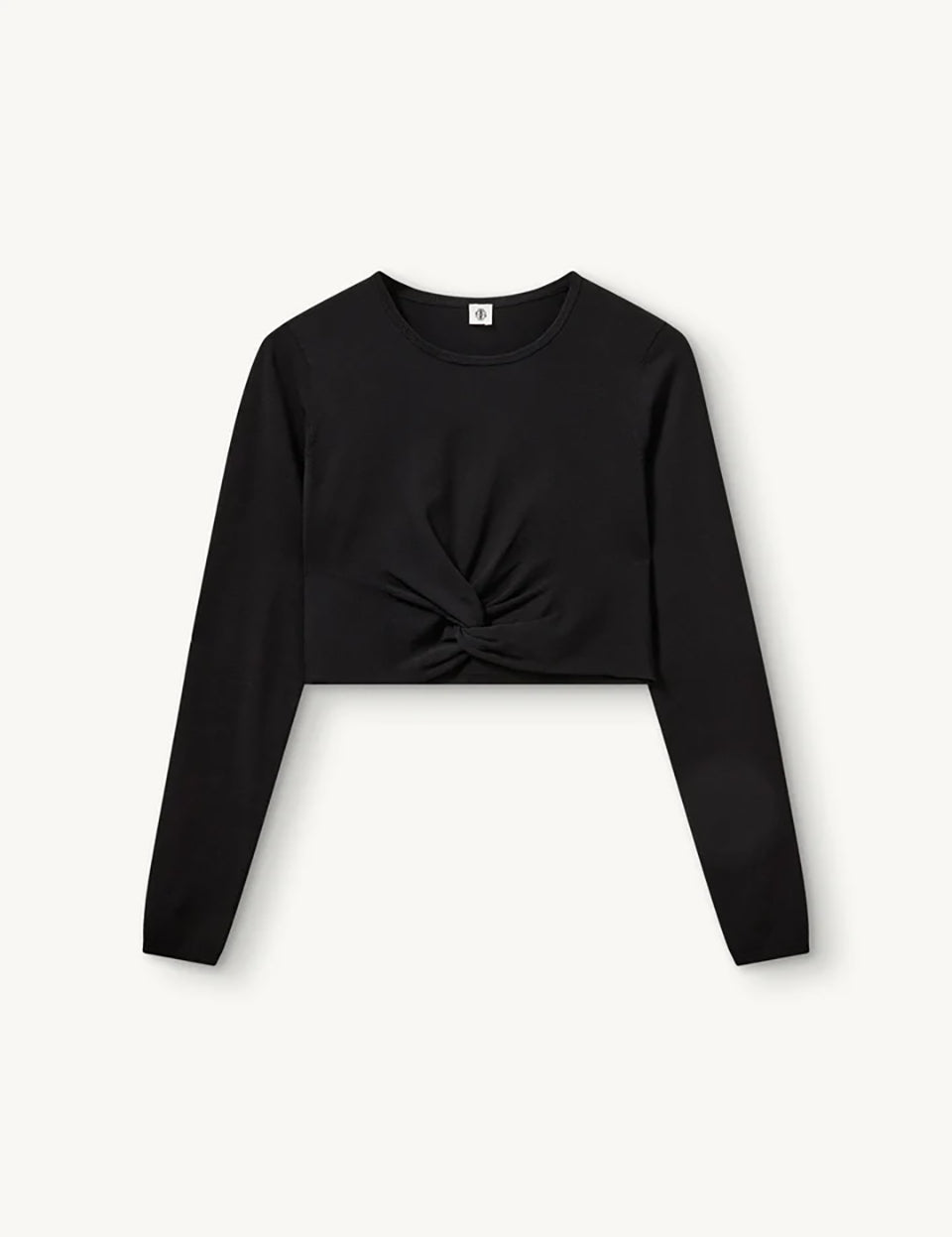Czarny, dopasowany top Madison Black marki The Garment o minimalistycznym, wyrazistym kroju. Ma okrągły, zabudowany dekolt i długie rękawy. U dołu materiał jest zebrany i związany w supeł, co tworzy delikatne marszczenie i skróconą długość odsłaniającą brzuch. Wykonany z miękkiej, przylegającej do ciała tkaniny.

-Dopasowany krój

-Skrócona długość&nbsp;

-Zamów top w swoim standardowym rozmiarze