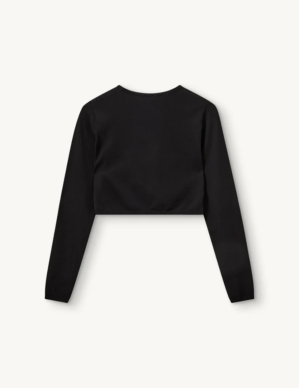 Czarny, dopasowany top Madison Black marki The Garment o minimalistycznym, wyrazistym kroju. Ma okrągły, zabudowany dekolt i długie rękawy. U dołu materiał jest zebrany i związany w supeł, co tworzy delikatne marszczenie i skróconą długość odsłaniającą brzuch. Wykonany z miękkiej, przylegającej do ciała tkaniny.

-Dopasowany krój

-Skrócona długość&nbsp;

-Zamów top w swoim standardowym rozmiarze