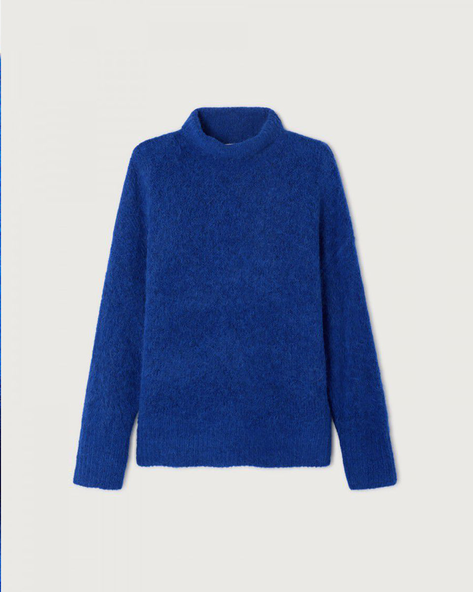 Gruby, luźny sweter Niby Blue Marl marki American Vintage z długim rękawem i golfem. Zakończony ściągaczami. Wykonany z ultraciepłej, miękkiej dzianiny z alpaką. Noś go z jeansami lub spódnicą, aby uzyskać swobodny look.&nbsp;