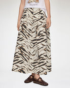 Długa, maxi spódnica Printed Long Skirt GANNI Egret wyróżnia się wyrazistym, zwierzęcym motywem tygrysich pasów. Ma trapezowy, lekko rozszerzany ku dołowi krój o swobodnej linii oraz obniżoną talię. Z tyłu posiada elastyczne marszczenie. Spódnica sięga do polowy łydki i świetnie prezentuje się w stylizacjach z prostymi t-shirtami oraz płaskimi butami. Wykonana z bawełny i elastanu.&nbsp;

-Zwierzęcy, wyrazisty print

-Długość maxi

-Bawełniana tkanina z elastanem
