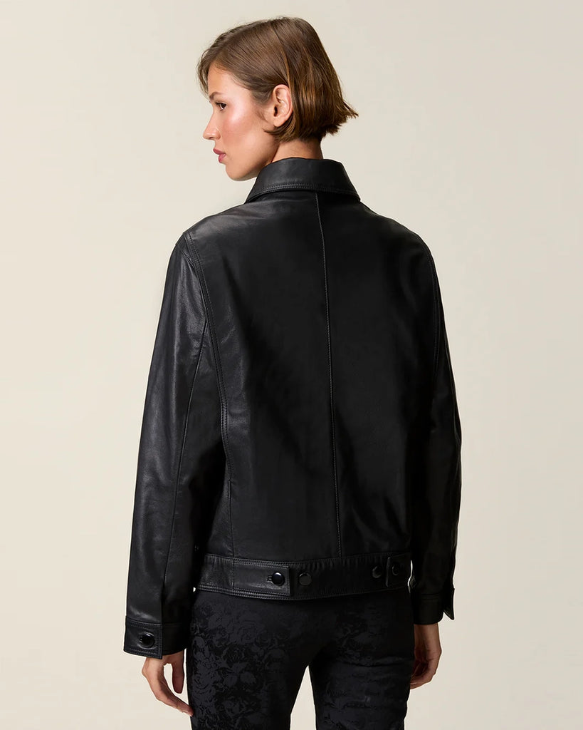 Czarna, krótka kurtka skórzana Stan Rouje o prostym kroju. Posiada kołnierzyk i dwie, boczne kieszenie. Z przodu i przy mankietach rękawów zapinana na guziki. Kurtka ma podszewkę we wzór w grochy.