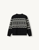 Luźny, wełniany sweter Faroe The Garment w geometryczny, kontrastowy wzór. Posiada okrągły dekolt, opadające ramiona i długie rękawy. Wykończony ściągaczami. Sweter ma prosty krój i długość za biodra. Wykonany z grubej i miękkiej, wełnianej dzianiny z kaszmirem