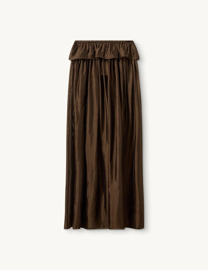 Elegancka, brązowa spódnica maxi Gilian The Garment z wysokim stanem i elastyczną talią. Na biodrach posiada falbanę. Wykonana z lekkiej, częściowo transparentnej organzy